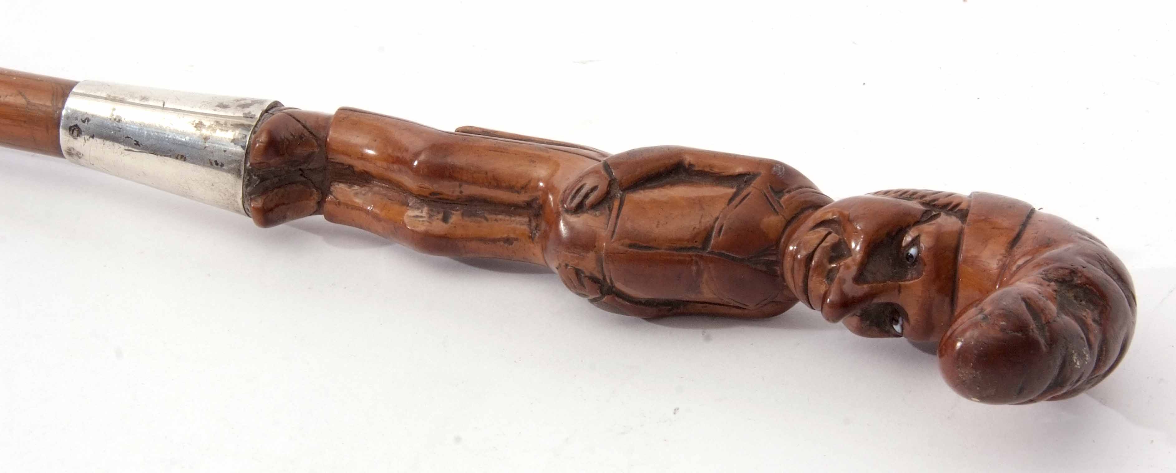 White metal mounted figural walking stick, the carved handle modelled as a standing portly gentleman