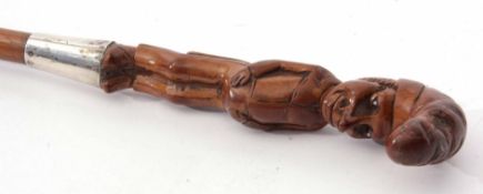 White metal mounted figural walking stick, the carved handle modelled as a standing portly gentleman