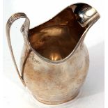 George V milk jug of polished form with applied reeded rim and strapwork handle, height 11.5cm,
