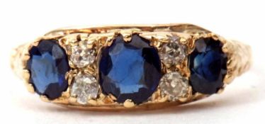 Sapphire and diamond ring featuring three graduated faceted sapphires interspersed by four small