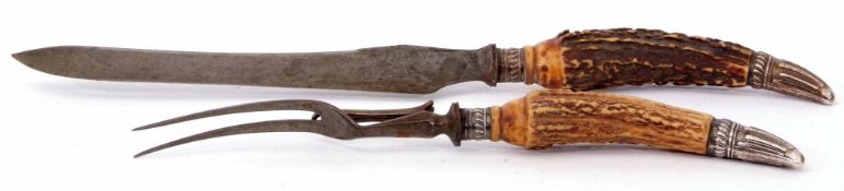 Late 19th century carving knife and fork with embossed silver mounts and stag antler handles to a