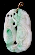 Carved jade pendant of oval pierced form with green vibrant highlights on a yellow metal bale, 4 x