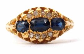 Edwardian 18ct gold sapphire and diamond cluster ring featuring three oval graduated sapphires,