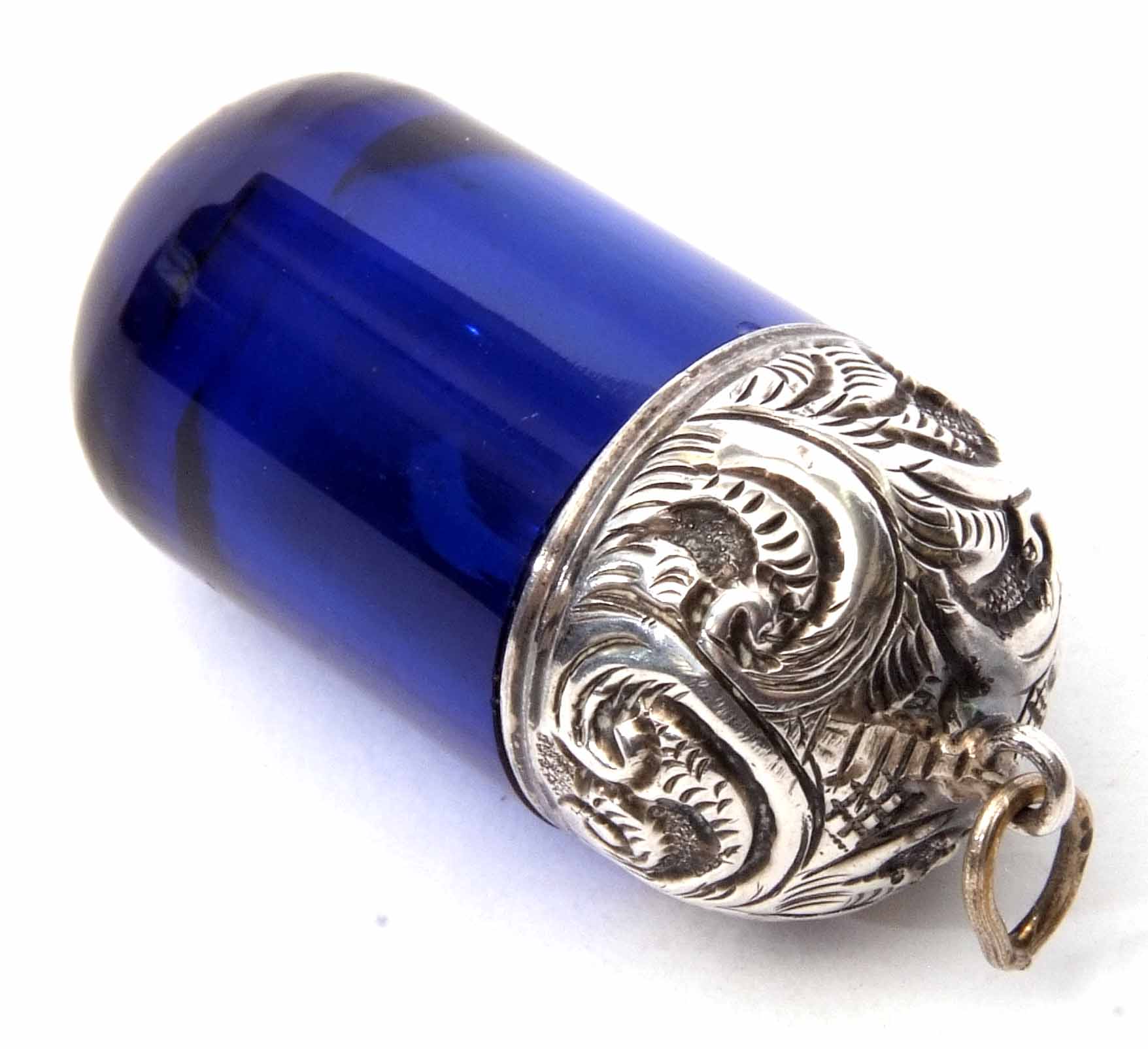 White metal mounted and cobalt blue glass phial, the screw down foliate embossed cover with ring