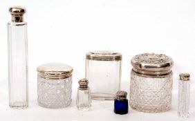 Mixed Lot: comprising four various faceted and cut glass silver lidded toiletry bottles, two of