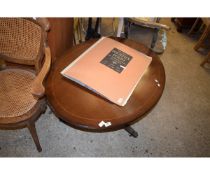 REPRODUCTION MAHOGANY OVAL COFFEE TABLE ON A TRIPOD BASE WITH BRASS CASTERS