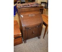 MID-20TH CENTURY OAK FRAMED BUREAU WITH DROP FRONT, SINGLE DRAWER OVER CUPBOARD DOOR