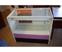 WHITE MELAMINE JEWELLERS CABINET WITH GLASS TOP AND FRONT WITH SLIDING DOORS TO BACK