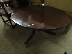 REPRODUCTION MAHOGANY OVAL COFFEE TABLE ON A TRIPOD BASE WITH BRASS CASTERS