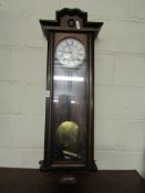 WALNUT AND EBONISED WALL CLOCK WITH ENAMEL ARABIC CHAPTER RING