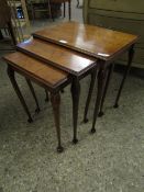 WALNUT NEST OF THREE TABLES ON PAD FEET