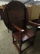 OAK FRAMED SINGLE SEATER METAMORPHIC CHAIR/TABLE WITH CIRCULAR CARVED TOP