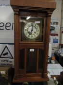 OAK CASED DIAL CLOCK WITH ENAMEL AND BRASS DIAL. REEDED COLUMNS AND GLASS PANELS