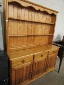 WAXED PINE DRESSER, TOP FITTED WITH TWO FIXED SHELVES, BASE WITH THREE DRAWERS OVER THREE PANELLED