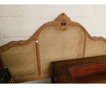 TWO CARVED DOUBLE HEADBOARDS, ONE WITH THREE CANE PANELS, ONE LACKING PANELS