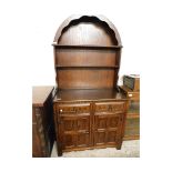 EARLY 20TH CENTURY DRESSER WITH ARCHED TOP WITH TWO FIXED SHELVES, THE BASE WITH TWO DRAWERS OVER