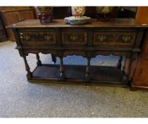 OAK FRAMED AND BURR OAK BANDED DRESSER BASE WITH THREE DRAWERS WITH TURNED SUPPORTS AND OPEN SHELF