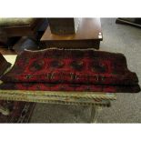 RED GROUND BOKHARA CARPET WITH REPEATING LOZENGE CENTRE
