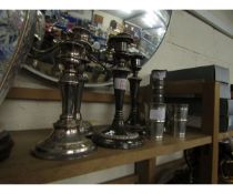 FOUR ASSORTED SILVER PLATED CANDLE STICKS TOGETHER WITH A CORCHEVAL PART LIQUOR SET