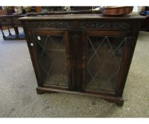 EARLY 20TH CENTURY OAK FRAMED TWO LEADED AND GLAZED DOOR BOOKCASE WITH CARVED DETAIL