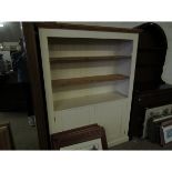 WHITE PAINTED AND PINE FRAMED BOOKCASE WITH TWO ADJUSTABLE SHELVES OVER TWO PANELLED CUPBOARD DOORS