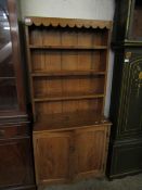 19TH CENTURY PINE DRESSER OF SMALL PROPORTIONS WITH THREE OPEN SHELVES OVER TWO PANELLED CUPBOARD