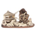 Intricate Japanese diorama depicting a mountainous landscape with pavilions and figures in wood,