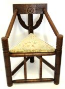 Carved oak "Totem" chair, bar back, joined by two ring turned swept arms terminating in
