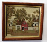 Early 20th century wool work picture depicting cottages within a simulated rosewood frame, 29 x 31cm