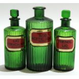 Group of green glass apothecary bottles, the reeded bodies with an inset "poison" label