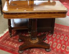 19th century mahogany fold-top card table raised on a foliate moulded cylindrical column terminating