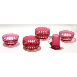 Group of 13 small cranberry coloured dessert bowls and a cranberry jug, the bowls with star cut