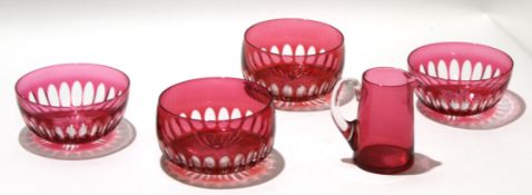 Group of 13 small cranberry coloured dessert bowls and a cranberry jug, the bowls with star cut