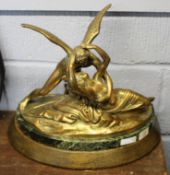 Large gilt bronze style figure of an angel rescuing a lady, the figure resting on an oval marble