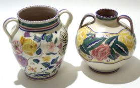 Two mid-20th century Poole Pottery vases, both with loop handles, one with a floral design, possibly