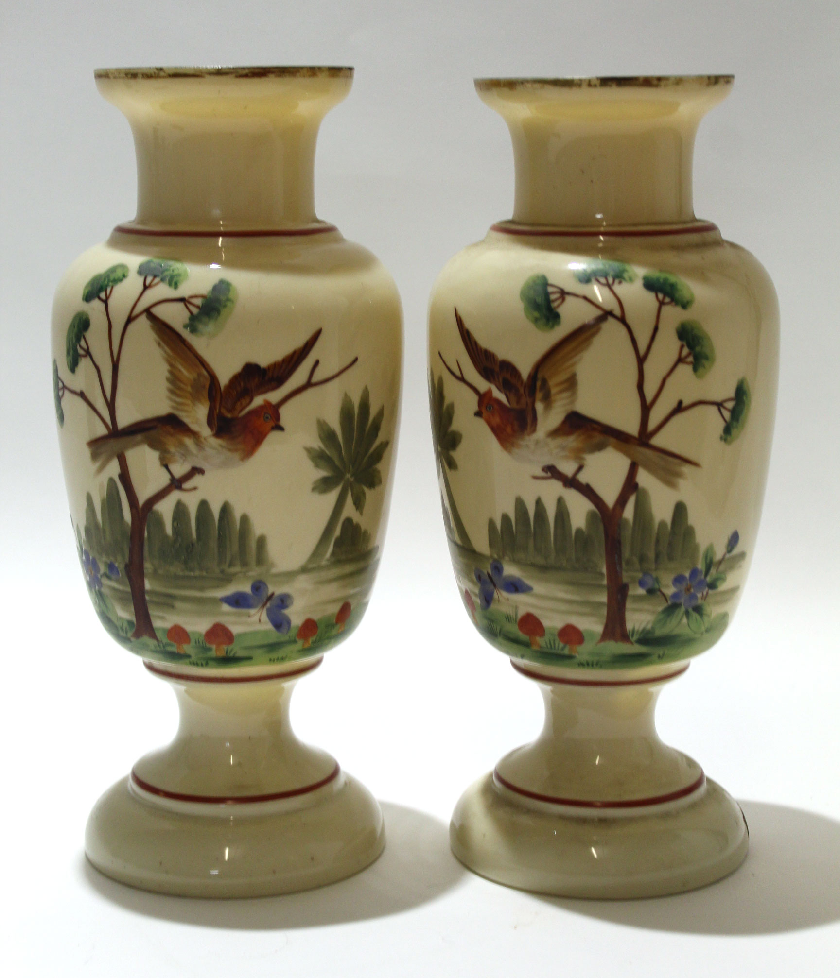 Pair of glass vases of baluster form, the beige bodies painted in polychrome with birds in branches,