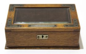 Early 20th century oak cigarette box, the cover with glass inset and metal mounts including a