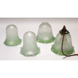 Group of four glass shades with swirling Art Nouveau design, 17cm high