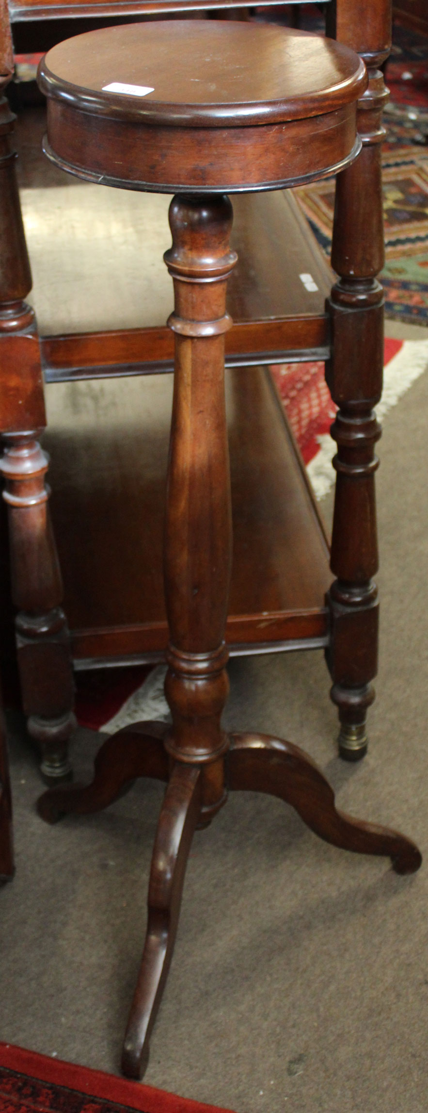 Mahogany jardiniere stand, the cylindrical top raised on a ring turned column terminating in a
