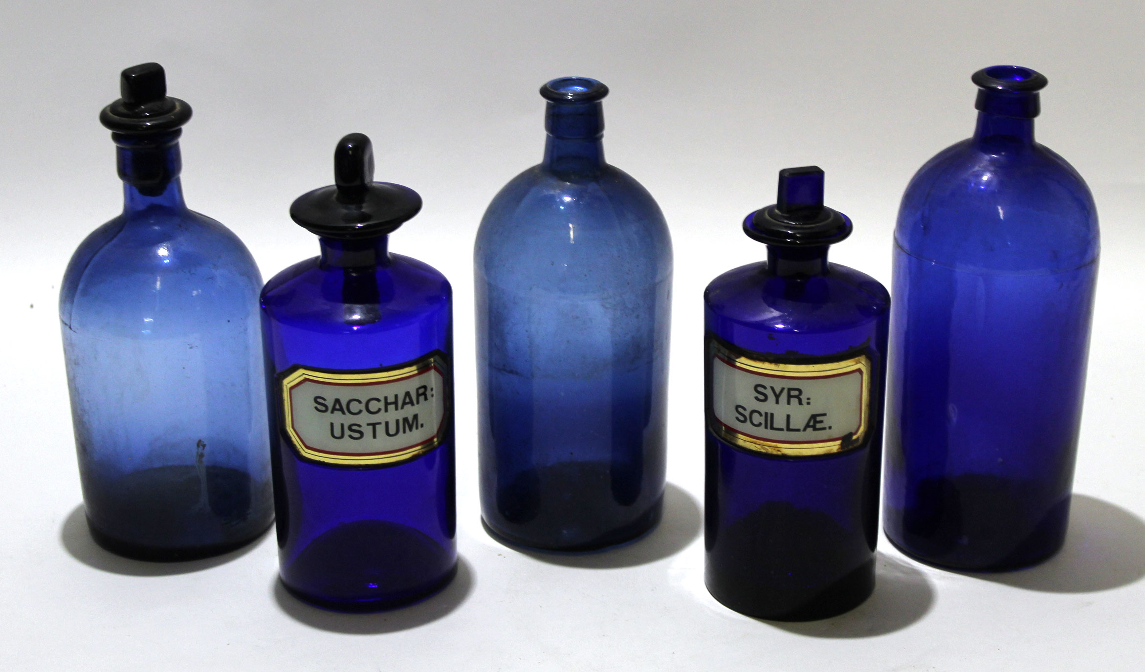 Group of blue coloured apothecary bottles with stoppers