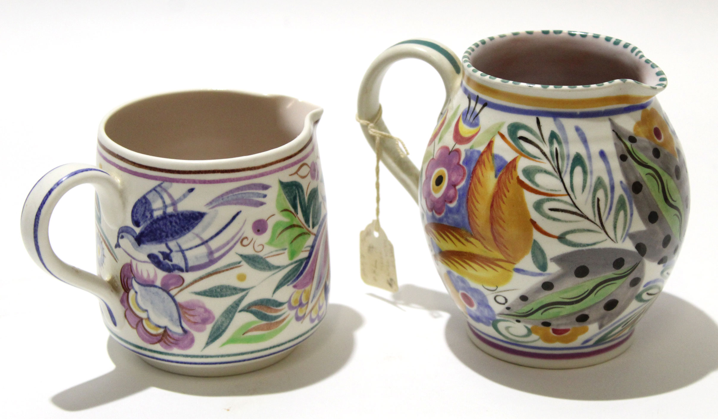 Two Poole Pottery jugs, one with a bluebird type design by Betty Godby circa 1950s, together with