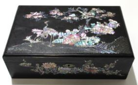 Chinese writing box with mother of pearl design of two cranes amongst rock work, 38cm long