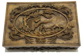 Oriental hardwood rectangular box, the lid carved with dragons and central rural scene, 50cm wide