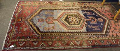 Caucasian carpet, central panel with geometric lozenge within a triple gull border, mainly red and