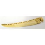 Carved ivory paper knife with elephant finial, together with a carved ivory small model of an