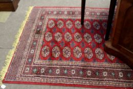 Modern Caucasian rug, central panel of lozenges, multi-gull border, mainly red field, 131 x 165cm