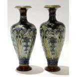 Pair of early 20th century Royal Doulton vases, the green ground decorated in Art Nouveau style with