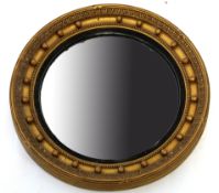 Regency style gilt circular wall mirror with ball moulded surround and convex centre, 49cm diam