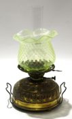 Brass table lamp with green shade, the brass reservoir with a chased rococo type design, 48cm high