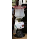 Late 19th century glass oil lamp, the white reservoir with floral design, the shade with floral